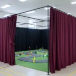 Burgundy modular curtain RCdrone course – “Indoor RC and drone track with burgundy modular curtain walls, showing enclosed course layout with adjustable partitions for events.