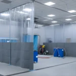 Large workshop area divided with clear vinyl curtain partitions to form a controlled spraying and work zone