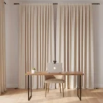 Neutral cream-colored backdrop curtain with laptop and minimal desk, ideal for Zoom or telehealth calls