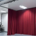 Red curtain divider creating a dedicated battery-testing area for EV prototype evaluation