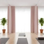 Soft pink Yoga & Wellness Zone Divider Curtains separating yoga areas in a bright, minimalistic studio