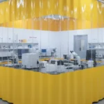 Yellow and transparent curtain enclosure forming a UV isolation lab setup around sensitive testing equipment