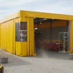 Yellow vinyl craft fair booth backdrop showing a fully enclosed vendor setup for better wind control and product display