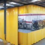 Yellow vinyl decontamination enclosure with clear windows used for isolating turnout gear cleaning zones