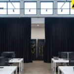 Black curtains hiding network servers in an open office workspace