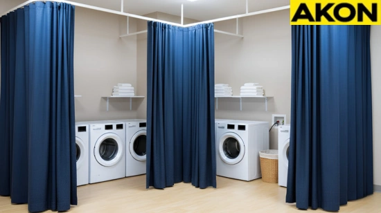 Blue fabric curtains providing separation between washers in a shared laundry room