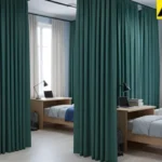 Green curtains dividing shared dorm beds into private sleeping areas