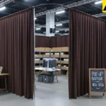 Heavy fabric curtains fully enclosing a staff-only staging zone at a pop-up retail event