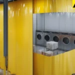 Industrial curtain wall creating a durable enclosure for a shared laundry room