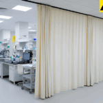 Clear vinyl curtain walls enclosing a temporary medical testing and screening areas