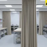 Neutral fabric curtains dividing a wide shared laundry room for privacy and order