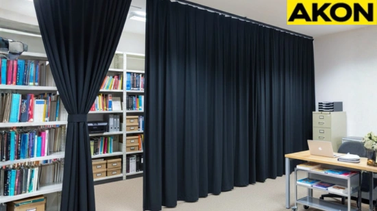 Office shelving concealed with black fabric closet and alcove cover curtains