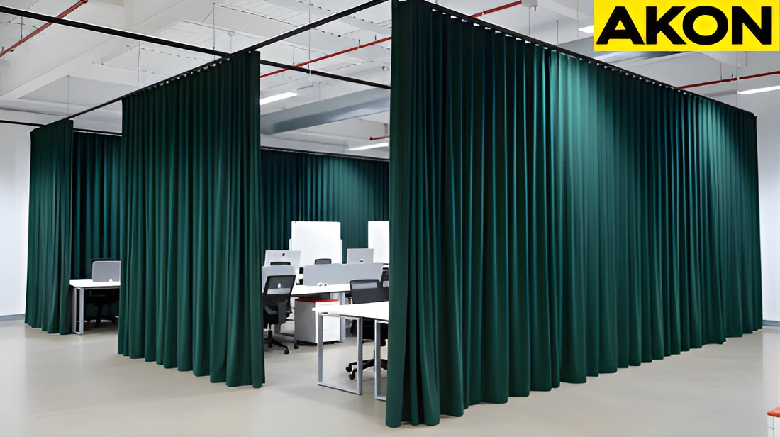Partition curtains dividing a warehouse-style office floor into functional zones