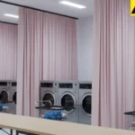 Soft fabric curtains separating laundry areas in an apartment building