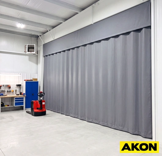 A commercial insulated curtain wall installed in a large industrial or warehouse facility to divide and temperature-control interior spaces.