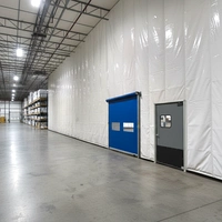 An insulated curtain installed inside a warehouse to separate temperature-controlled zones from general storage or loading areas.