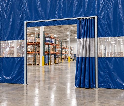 Slim free-standing steel frame in a full-height blue vinyl curtain wall, with a curtain on a track pushed aside to open the doorway
